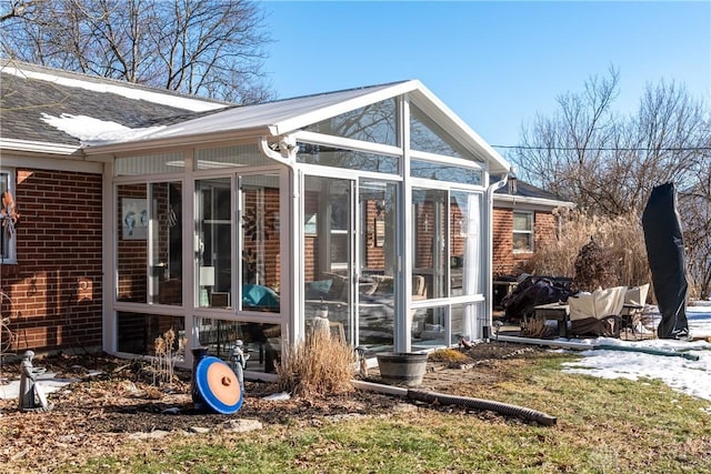 rear view of property featuring a sunroom