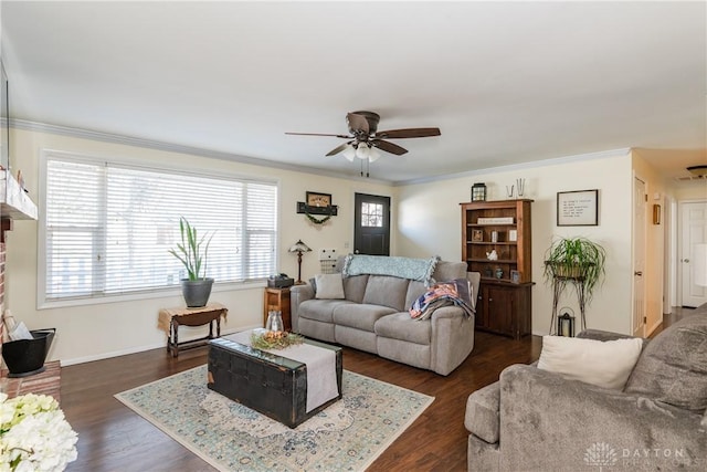 living room with dark hardwood / wood-style flooring, ornamental molding, and ceiling fan