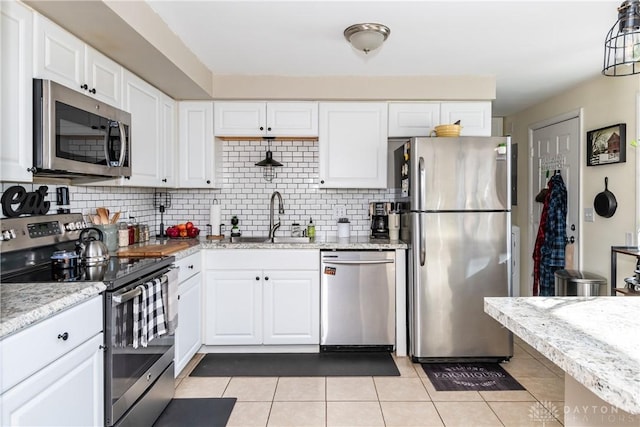 kitchen featuring white cabinetry, sink, decorative backsplash, and appliances with stainless steel finishes