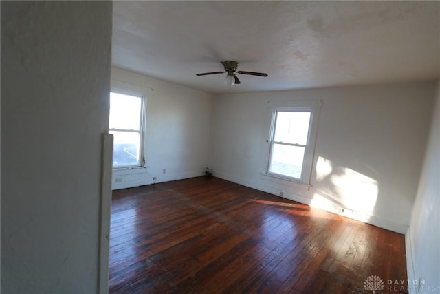 spare room featuring ceiling fan, hardwood / wood-style floors, and baseboards