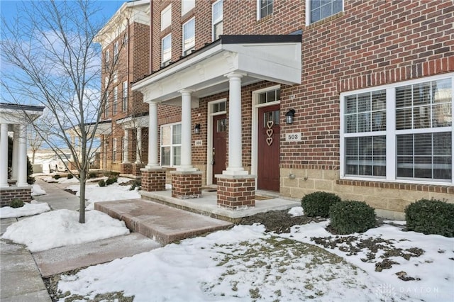 view of snow covered property entrance