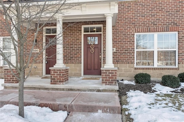 view of snow covered property entrance