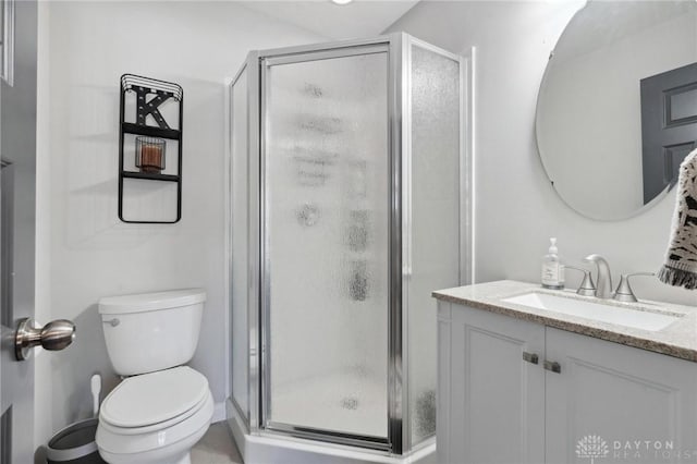 bathroom featuring walk in shower, vanity, and toilet