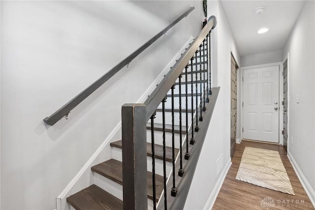 stairs with hardwood / wood-style floors