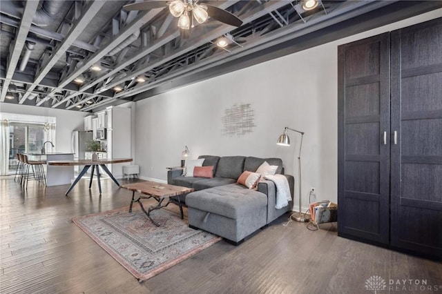 living room with hardwood / wood-style flooring and ceiling fan