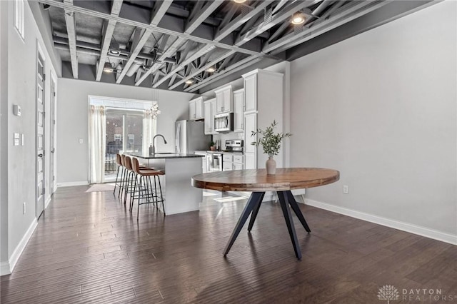 dining room featuring sink and dark hardwood / wood-style floors