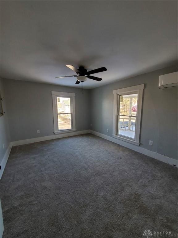 carpeted empty room with plenty of natural light, a wall mounted air conditioner, and ceiling fan