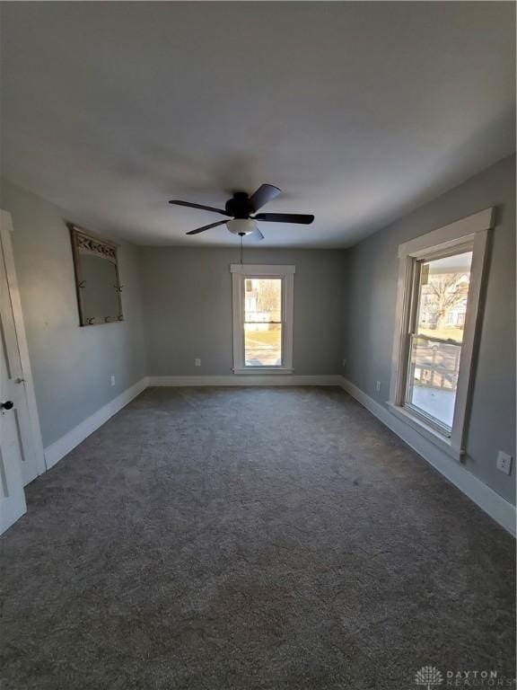 carpeted spare room with ceiling fan