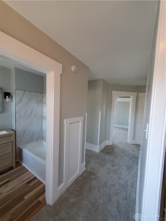 bathroom featuring vanity, hardwood / wood-style floors, and tub / shower combination