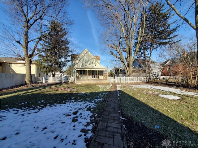 yard layered in snow with covered porch