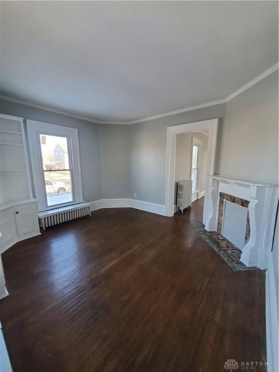 unfurnished living room featuring dark hardwood / wood-style flooring, radiator, and crown molding