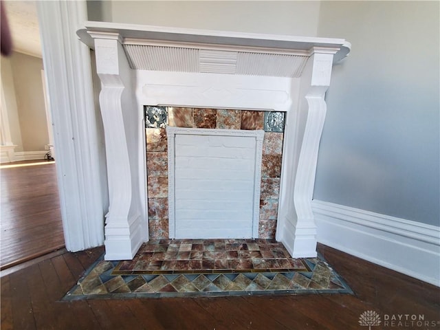 details with a fireplace, hardwood / wood-style floors, and decorative columns