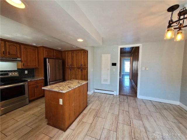 kitchen with baseboard heating, stainless steel appliances, tasteful backsplash, light stone countertops, and a kitchen island