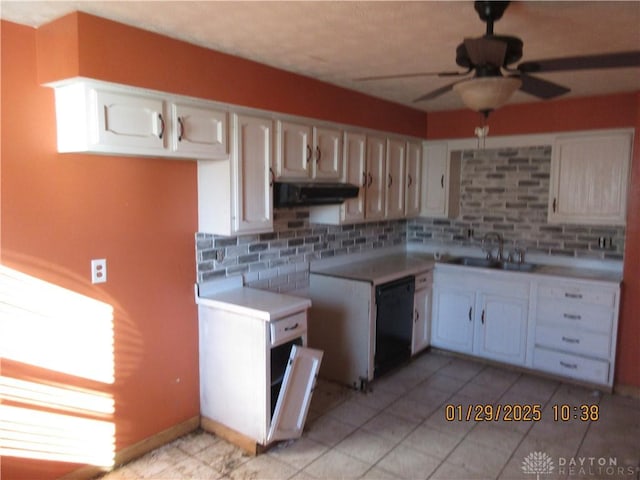 kitchen with sink, ceiling fan, white cabinetry, black dishwasher, and decorative backsplash