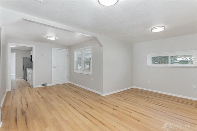 spare room featuring light wood-type flooring