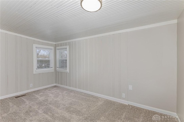 carpeted spare room with ornamental molding