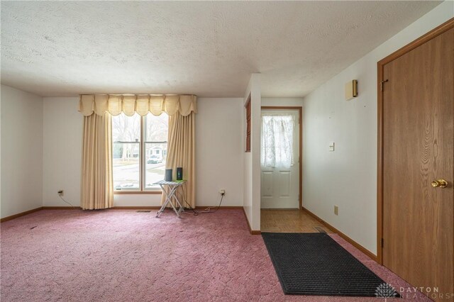 entryway with a textured ceiling and carpet