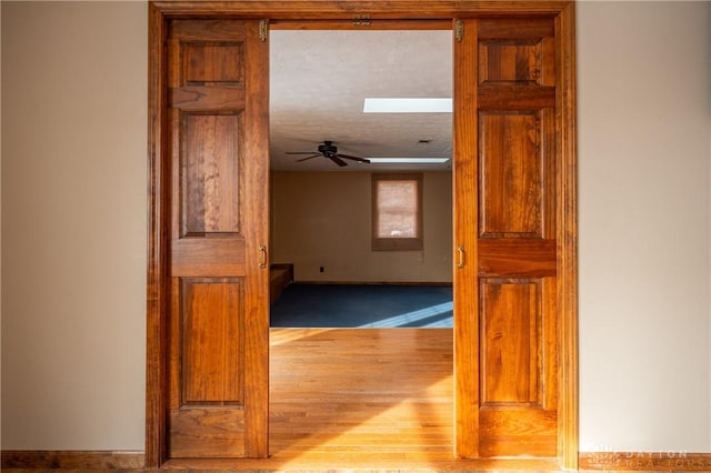 hall with a skylight and a textured ceiling