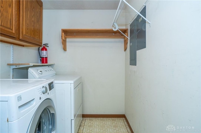 washroom featuring cabinet space, baseboards, separate washer and dryer, and light floors