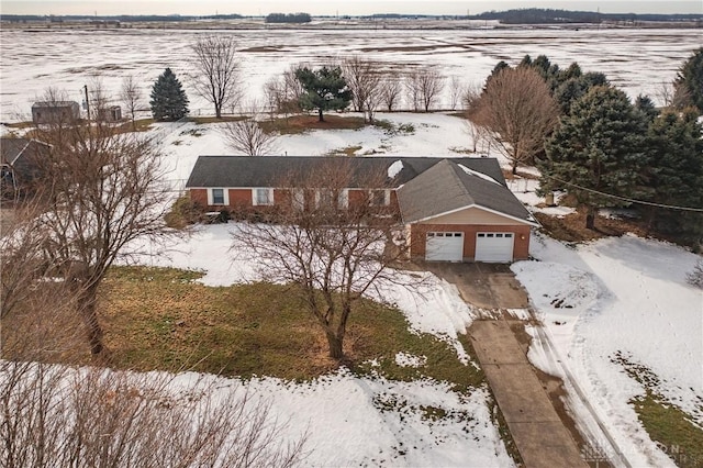 snowy aerial view featuring a rural view