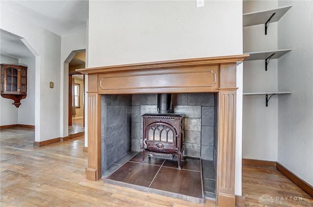 room details featuring hardwood / wood-style flooring and a wood stove