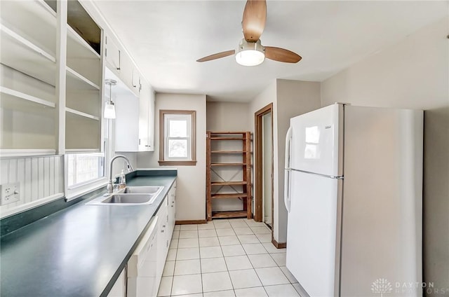 kitchen with light tile patterned flooring, sink, white cabinets, ceiling fan, and white appliances