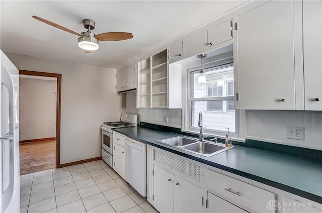 kitchen with sink, white appliances, light tile patterned floors, ceiling fan, and white cabinets