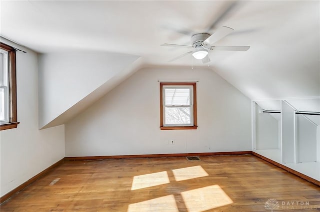 bonus room with vaulted ceiling, ceiling fan, and light hardwood / wood-style flooring