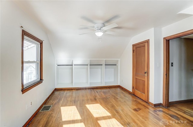 additional living space featuring vaulted ceiling, ceiling fan, and light wood-type flooring