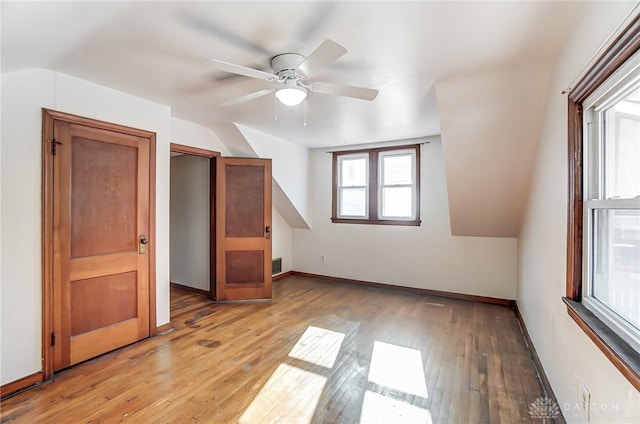 additional living space featuring vaulted ceiling, light hardwood / wood-style floors, and ceiling fan