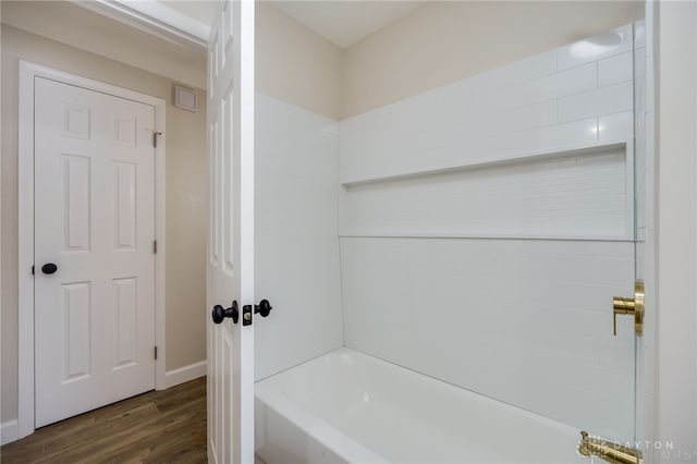 bathroom with tub / shower combination and wood finished floors