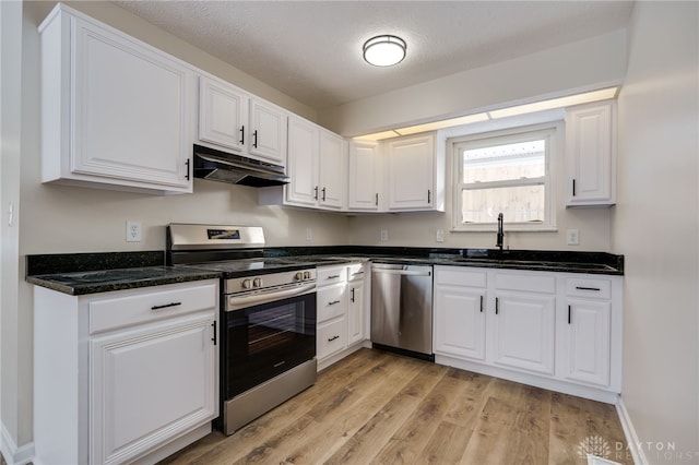 kitchen with stainless steel appliances, light wood-style flooring, white cabinetry, and under cabinet range hood