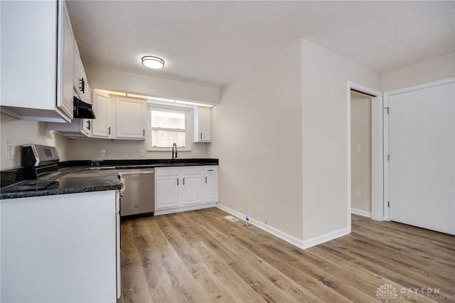 kitchen featuring light wood finished floors, range hood, white cabinets, and stainless steel dishwasher