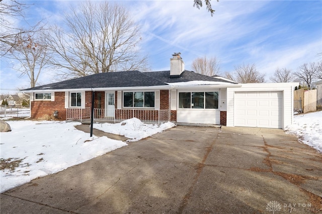 single story home featuring a garage, covered porch, brick siding, driveway, and a chimney