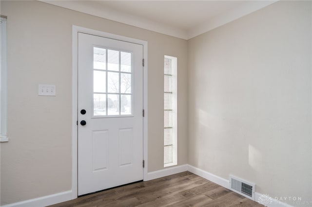 doorway to outside with visible vents, baseboards, and wood finished floors