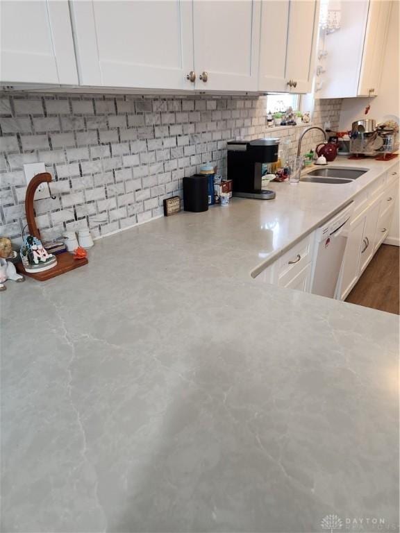 kitchen with white cabinetry, sink, and dishwasher