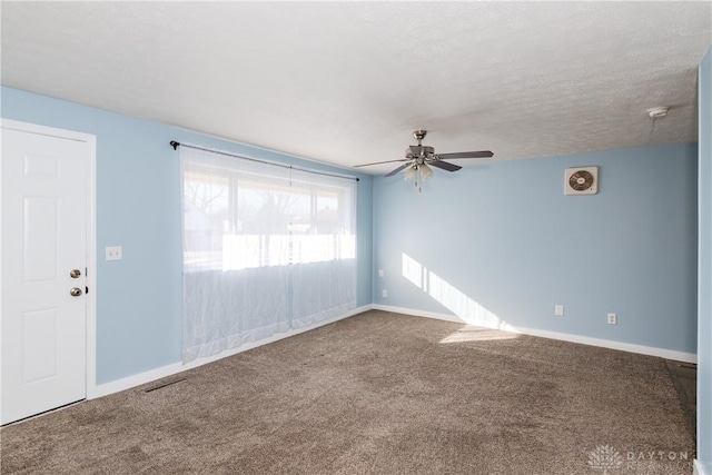 carpeted empty room featuring a textured ceiling and ceiling fan