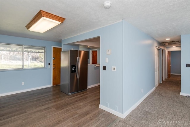 interior space featuring dark wood-type flooring and a textured ceiling