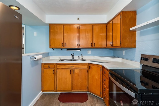 kitchen with extractor fan, sink, dark hardwood / wood-style flooring, stainless steel electric stove, and decorative backsplash