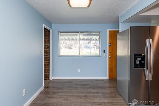 kitchen with stainless steel refrigerator with ice dispenser and dark hardwood / wood-style floors