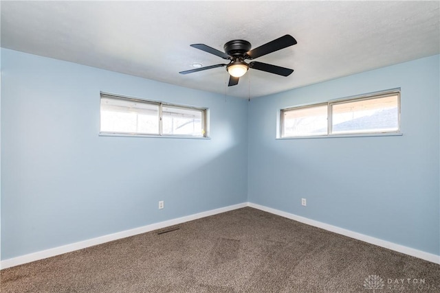 carpeted spare room featuring ceiling fan