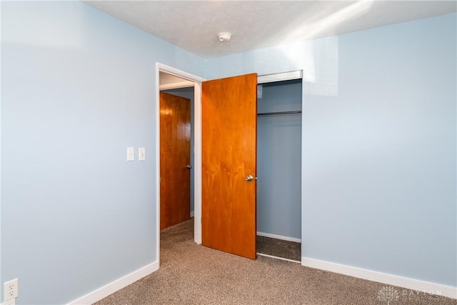 unfurnished bedroom with a closet and carpet