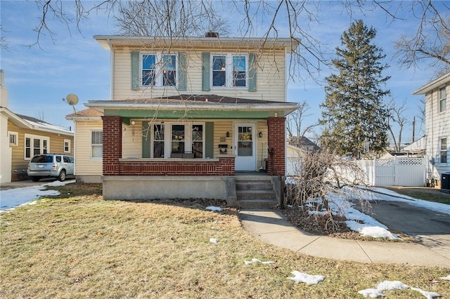 front facade featuring a front lawn and a porch