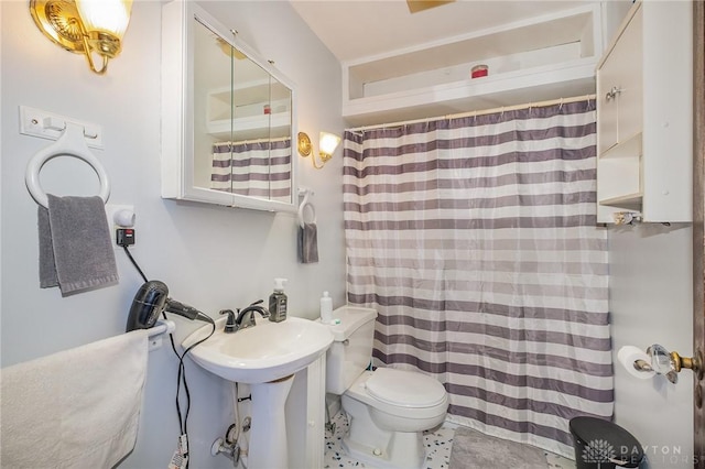 bathroom featuring sink, toilet, and walk in shower