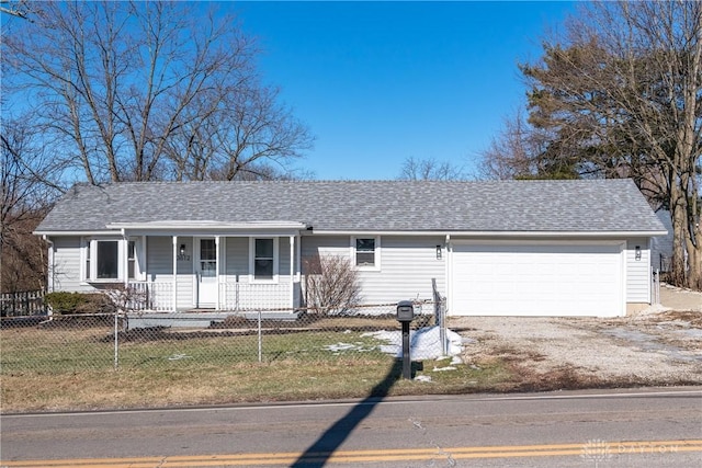 ranch-style house featuring a garage, a front lawn, and covered porch