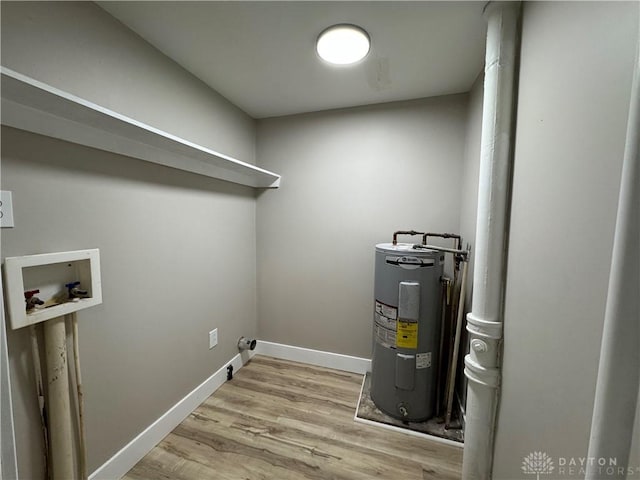 washroom featuring hookup for a washing machine, electric water heater, and light hardwood / wood-style flooring