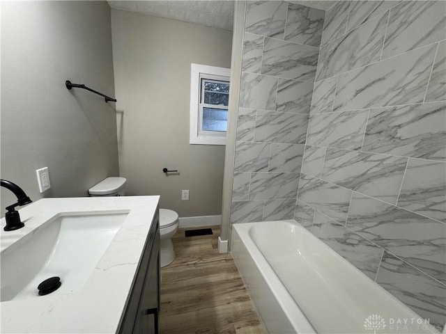 bathroom featuring vanity, wood-type flooring, and toilet