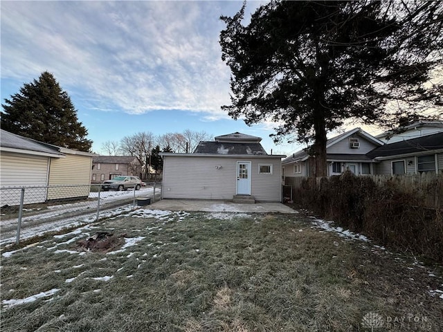 snow covered property featuring a patio and a yard