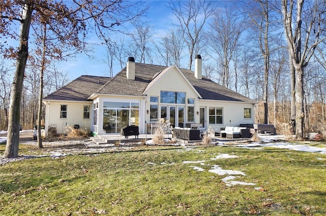 rear view of house featuring an outdoor living space, a yard, a patio area, and a jacuzzi