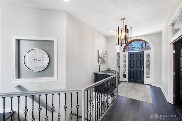 foyer entrance featuring a notable chandelier and dark hardwood / wood-style floors